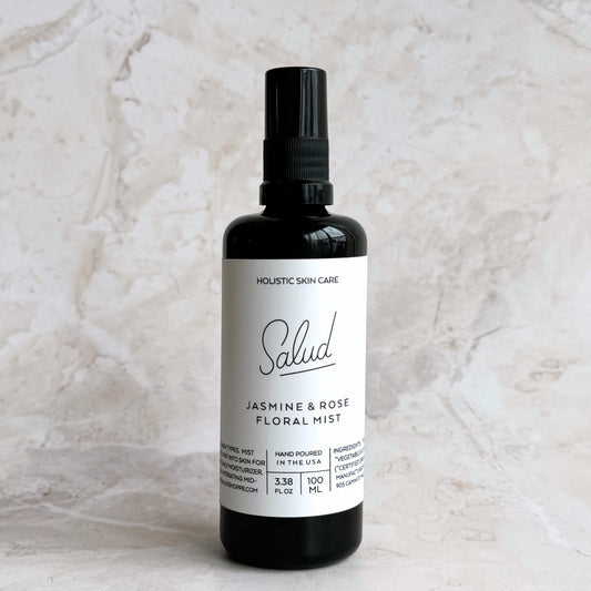 Bottle of Salud Jasmine & Rose Floral Mist on a marble background